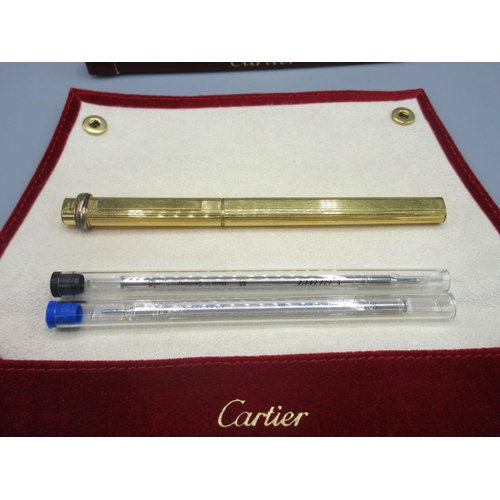 27 - Cartier gold plated ballpoint pen with two refills, in cartier pouch