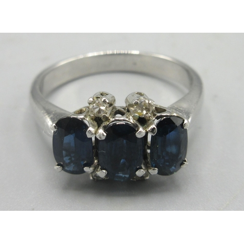 164 - 18ct white gold ring set with three oval cut sapphires and four small diamonds, stamped 18k, size N,... 