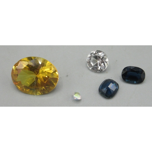 180 - Two unmounted blue sapphires, a yellow sapphire, approx. 6.0ct, and two clear stones (tested negativ... 