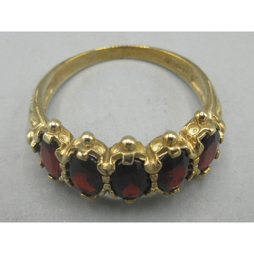 17 - 9ct yellow gold ring set with five oval cut garnets in ornate claw settings, stamped 375, size O, 3.... 