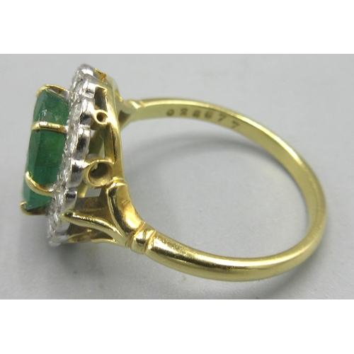 23 - 18ct yellow gold emerald and diamond cluster ring, the central oval cut diamond surrounded by a halo... 