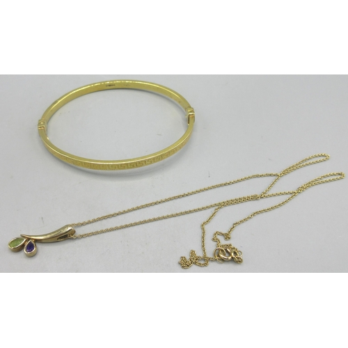 700 - 9ct yellow gold hinged bangle with Greek key design, and a  yellow metal pendant set with purple and... 