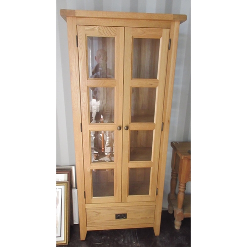 711 - Contemporary oak display cabinet, pair of four bevelled panel doors above a drawer, W78cm D36cm H181... 