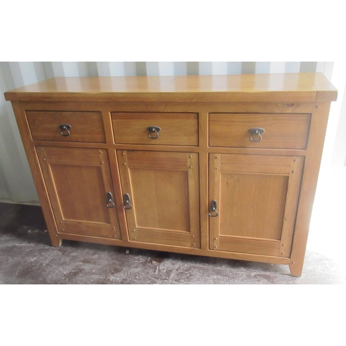 712 - Contemporary oak side cabinet, three drawers above three doors, W140cm D43cm H87cm