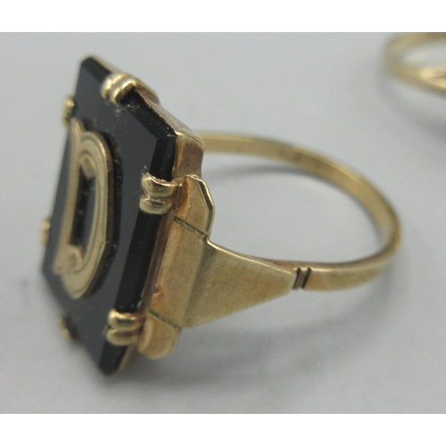 98 - 9ct gold ring set with polished black stone with D initial, size O1/2, stamped 9ct, a 9ct yellow gol... 