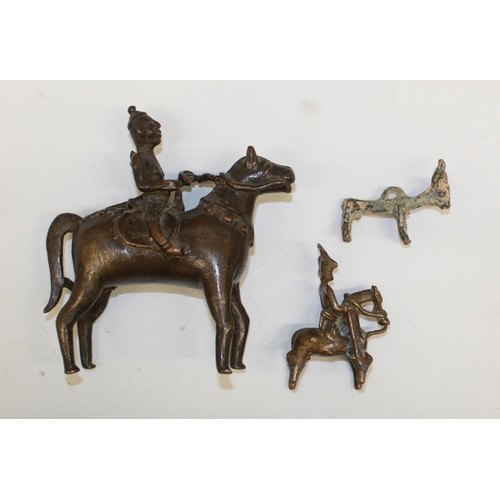 559 - Two cast bronze Indian 'spirit rider' figurines and a bronze bull