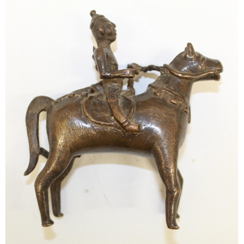 559 - Two cast bronze Indian 'spirit rider' figurines and a bronze bull