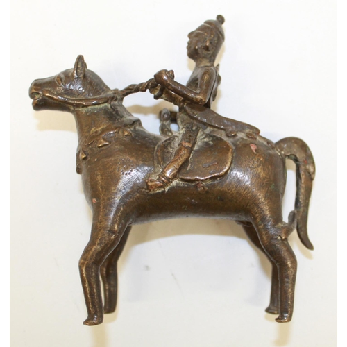 559 - Two cast bronze Indian 'spirit rider' figurines and a bronze bull