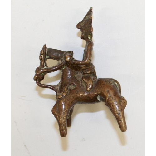 559 - Two cast bronze Indian 'spirit rider' figurines and a bronze bull