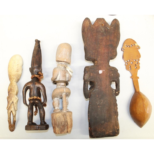 561 - Three carved figures originating from Africa and Indonesia, a carved wooden spoon and a carved bone ... 