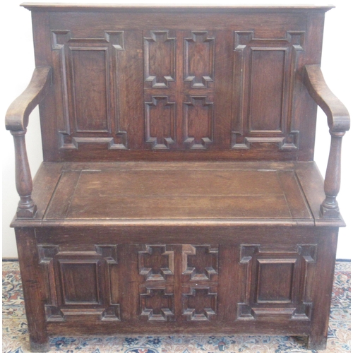 739 - 20th century oak box settle, with geometric moulded panels and hinged seat, W97cm D44cm H99cm