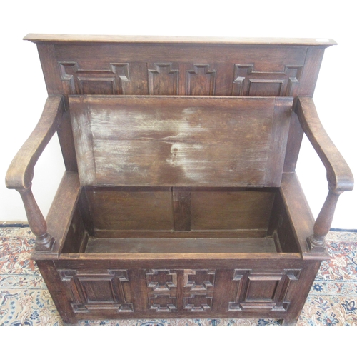 739 - 20th century oak box settle, with geometric moulded panels and hinged seat, W97cm D44cm H99cm