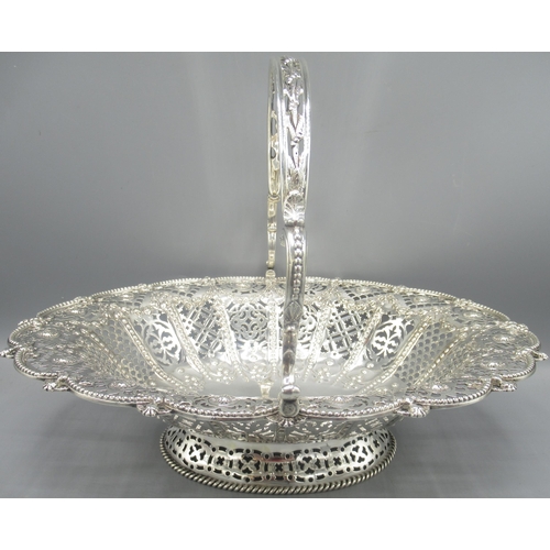 822 - George V silver basket in oval form with scalloped and beaded border, pierced sides, repousse decora... 