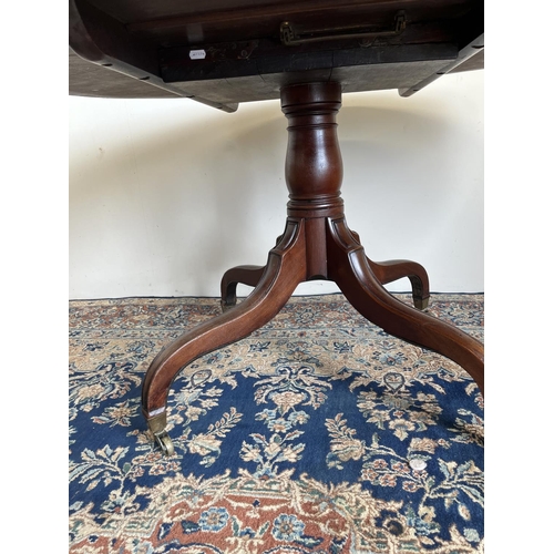 726 - 19th century mahogany breakfast table, oval tilt top on vase shaped support and four moulded down cu... 