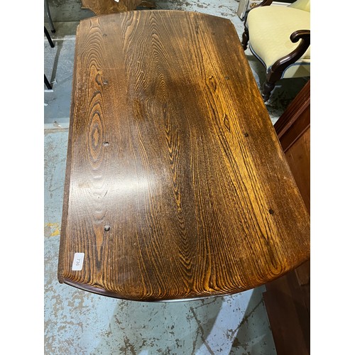 736 - Ercol elm circular drop leaf table, X shaped under strecher, D113cm