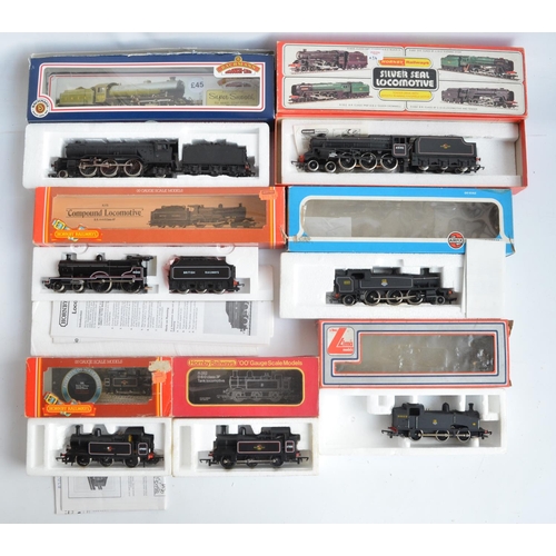 16 - Seven boxed OO gauge electric steam train models (various manufacturers), all BR black liveried to i... 