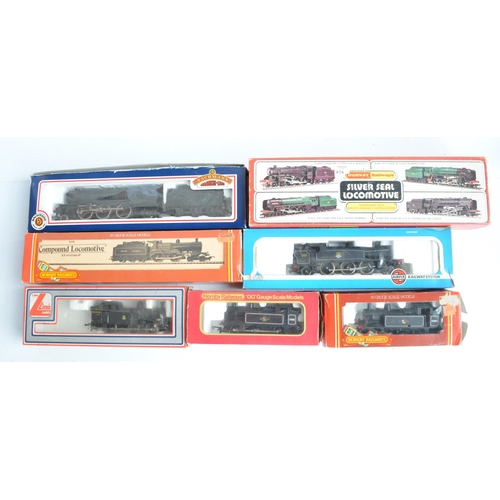 16 - Seven boxed OO gauge electric steam train models (various manufacturers), all BR black liveried to i... 