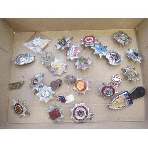 288 - Collection of firefighter badges, largely from the UK, including Middlesex, Cumbria, The Cayman Isla... 