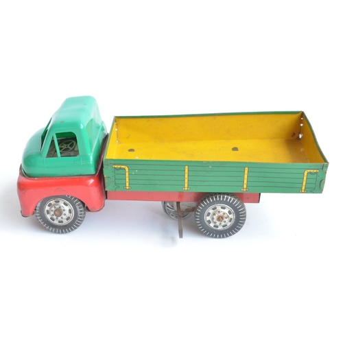 77 - Vintage British made clockwork tinplate and plastic truck model, no makers name, crack to left side ... 