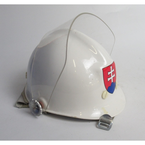 279A - Three eastern European firefighter helmets, including a C1998 Slovakian plastic helmet, a C1980s Yug... 