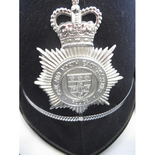 270 - Assortment of police-issue headwear. To include two black police caps, one marked 'North Yorkshire C... 