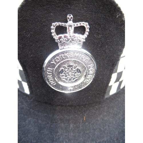 270 - Assortment of police-issue headwear. To include two black police caps, one marked 'North Yorkshire C... 