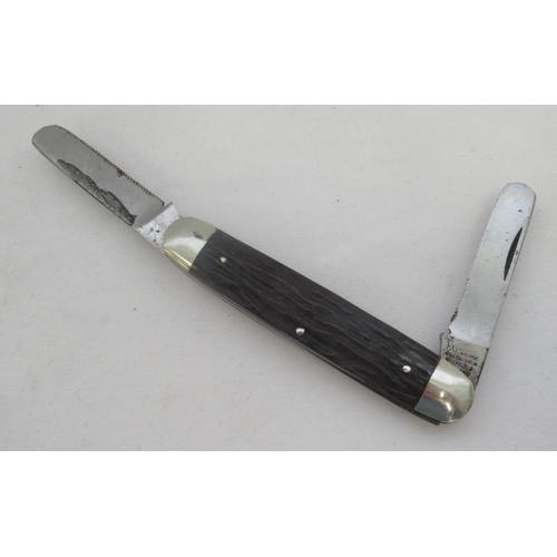 416B - Unusual George Wostenholm of Sheffield advertising knife with two serrated blades and a plastic hand... 