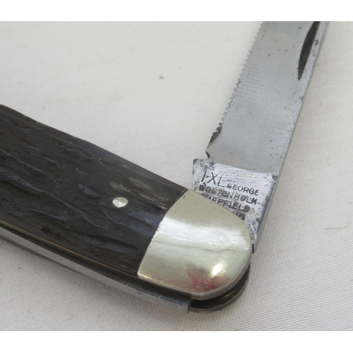 416B - Unusual George Wostenholm of Sheffield advertising knife with two serrated blades and a plastic hand... 