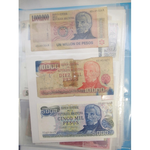 226 - Two folders containing assorted collection of International banknotes from Venezula, Angola, Ghana, ... 