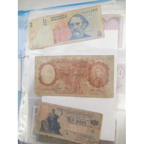 226 - Two folders containing assorted collection of International banknotes from Venezula, Angola, Ghana, ... 