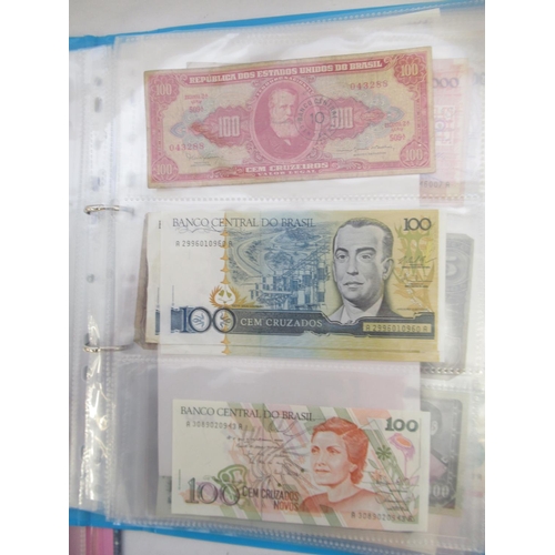 226 - Two folders containing assorted collection of International banknotes from Venezula, Angola, Ghana, ... 