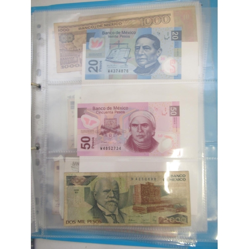 226 - Two folders containing assorted collection of International banknotes from Venezula, Angola, Ghana, ... 