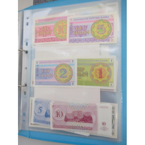 227 - Two folders containing mixed collection of International banknotes to inc. Mongolia, Moldova, Bosnia... 