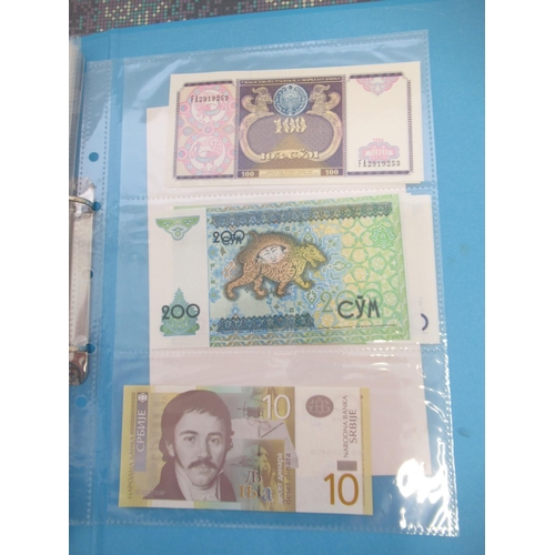 227 - Two folders containing mixed collection of International banknotes to inc. Mongolia, Moldova, Bosnia... 