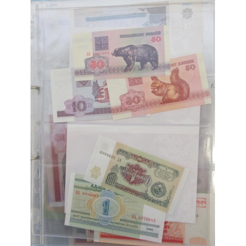 227 - Two folders containing mixed collection of International banknotes to inc. Mongolia, Moldova, Bosnia... 