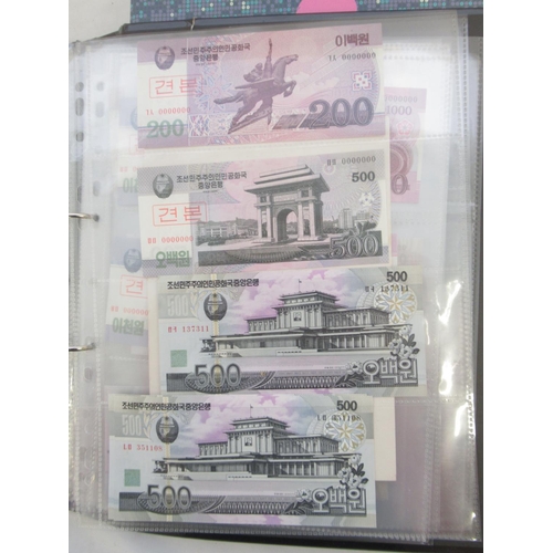 228 - Two folders containing mixed International banknotes from North Korea, Singapore, Indonesia, Malaysi... 