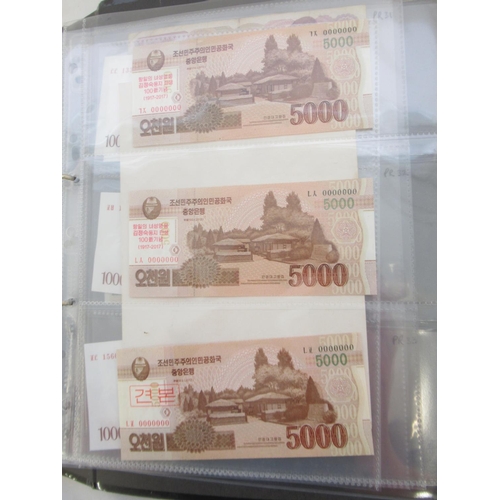 228 - Two folders containing mixed International banknotes from North Korea, Singapore, Indonesia, Malaysi... 