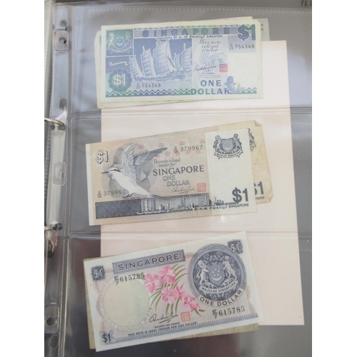 228 - Two folders containing mixed International banknotes from North Korea, Singapore, Indonesia, Malaysi... 