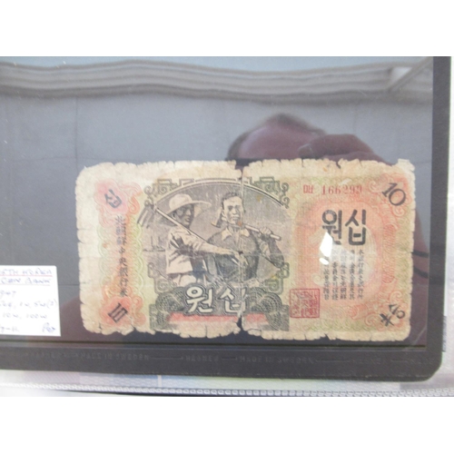 228 - Two folders containing mixed International banknotes from North Korea, Singapore, Indonesia, Malaysi... 