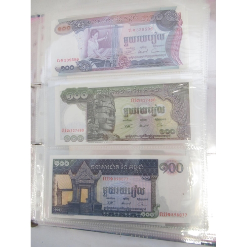 228 - Two folders containing mixed International banknotes from North Korea, Singapore, Indonesia, Malaysi... 