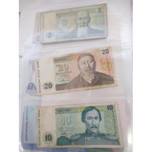 228 - Two folders containing mixed International banknotes from North Korea, Singapore, Indonesia, Malaysi... 