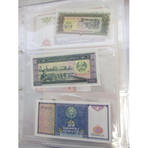 228 - Two folders containing mixed International banknotes from North Korea, Singapore, Indonesia, Malaysi... 