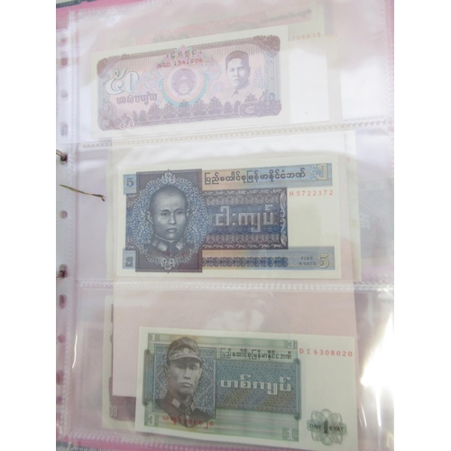 228 - Two folders containing mixed International banknotes from North Korea, Singapore, Indonesia, Malaysi... 