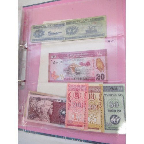 228 - Two folders containing mixed International banknotes from North Korea, Singapore, Indonesia, Malaysi... 