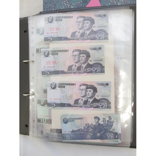 228 - Two folders containing mixed International banknotes from North Korea, Singapore, Indonesia, Malaysi... 