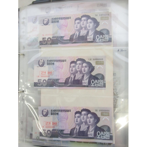 228 - Two folders containing mixed International banknotes from North Korea, Singapore, Indonesia, Malaysi... 