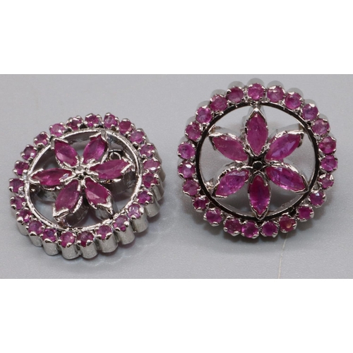 1008 - Silver and ruby floral earrings, the round fronts each set with twenty three round and six marquise ... 