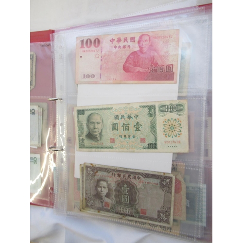 223 - Two folders containing International banknotes from India, Japan, Republic of China, Myanmar, Cambod... 