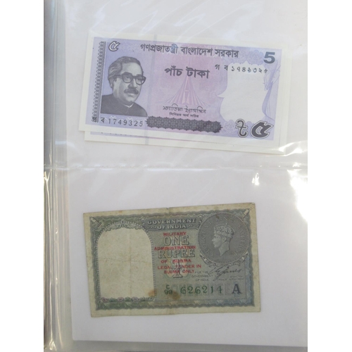 223 - Two folders containing International banknotes from India, Japan, Republic of China, Myanmar, Cambod... 