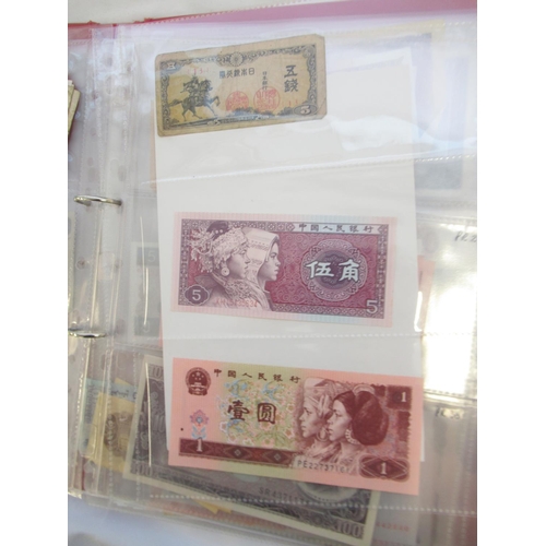 223 - Two folders containing International banknotes from India, Japan, Republic of China, Myanmar, Cambod... 